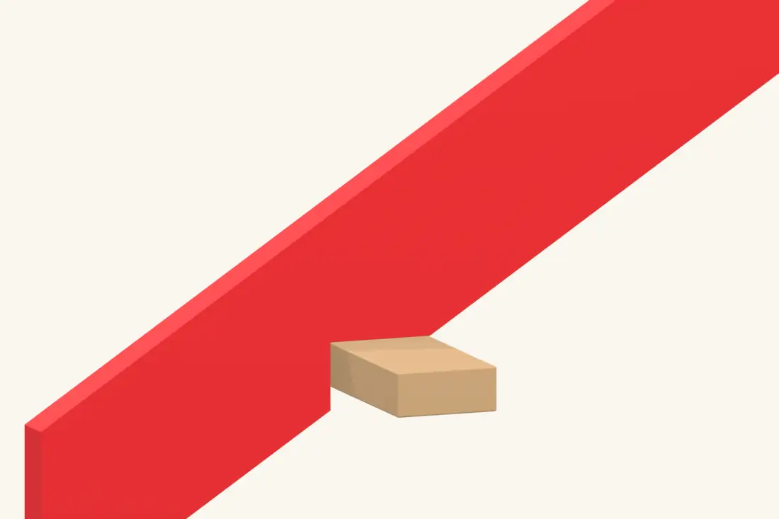 Close-up of the triangular birdsmouth seat where the rafter bears on the wall plate. Bright red marks the part being installed or checked.